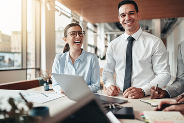 Laughing businesspeople talking with colleagues during an office