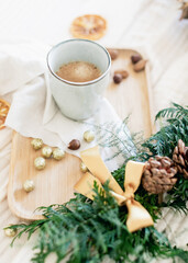 Coffee mug surrounded by Christmas decorations
