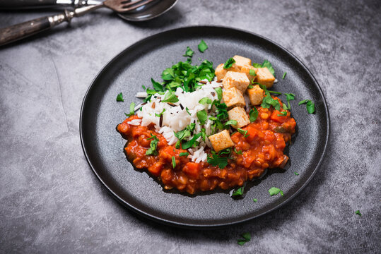 Vegan lentil and carrot bolognese with fried tofu and wild rice and basmati mixture