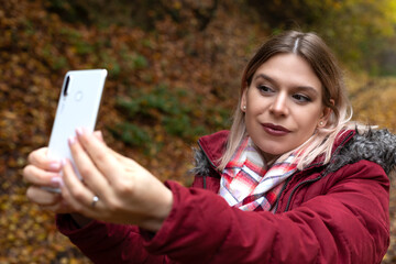 Woman making online content outdoor-autumn