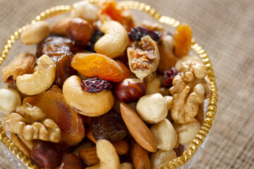 Mixed nuts in a glass plate. Healthy and natural nutrition .Cashew, Almond,, Hazelnut,, Fig,, Walnut,, Apricot,, Raisin,, Blueberry.