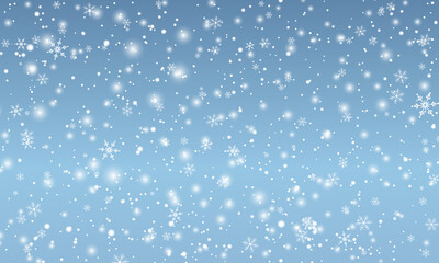 Snow background. Winter snowfall. White snowflakes on blue sky. Christmas background. Falling snow.