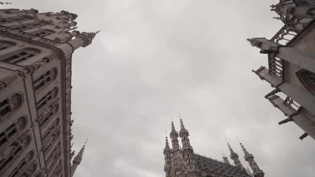Low angle shot of gothic architectural town hall, Saint Peter's Church and guild building on the Grand Square in Leuven, Belgium