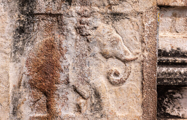 Hampi, Karnataka, India - November 4, 2013: Virupaksha Temple complex. closeup of molded and damaged elephant fresco on wall of brown stone.