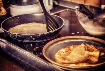 cooking at home: making French crepes in the pan for a festive breakfast