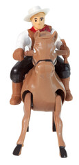 Plastic toy cowboy on galloping horse.