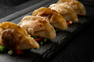Japanese gedza dumplings. Asian food. Dark background.