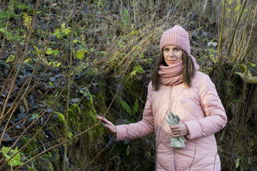 Girl in autumn clothes. Walking in nature in the park.