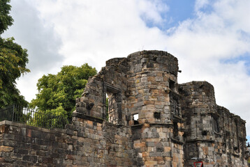 Fototapeta premium Old Ruined Stone Building against Blue Sky with White Clouds 
