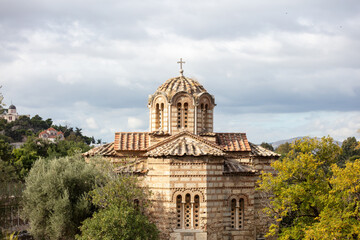 Fototapeta na wymiar Athens, Greece. Aghios Athanasios church upper part in Thissio area, blue cloudy sky background