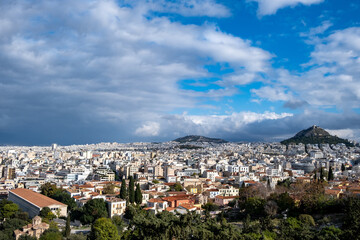 Fototapeta na wymiar Mount Lycabettus and Athens cityscape view from Areopagus hill in Greece, blue cloudy sky