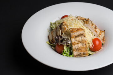 Cesar salad in white dish 