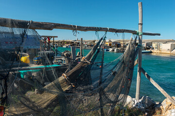 Fototapeta na wymiar Fishing nets and boats in the harbour at Leucate South of France