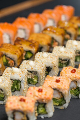 Different types of sushi and rolls in restaurant