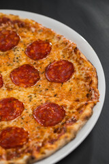 Pepperoni pizza on white dish 