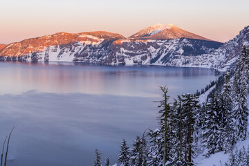 Beautiful sunset over Crater Lake in frost winter day. Crater Lake National Park, Oregon, USA	