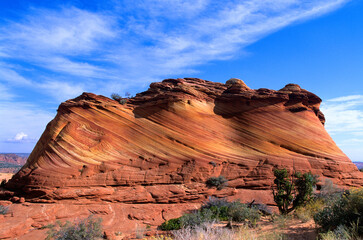 The "WAVE" area "Circus Tent" rock formation with high clouds passing bye.  In Coyote Buttes area of Vermilion Cliffs National Monument, Arizona, USA