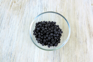  European black elderberry on a wooden background. (Sambucus nigra). Fruit black elderberry        
