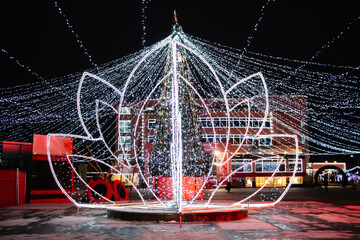 Street Christmas decor. Beautiful luminous flower of lights.