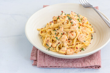 Creamy Shrimp Pasta Garnished with Basil and Chili Peppers CLose Up
