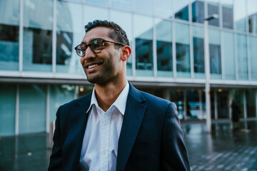 Portrait businessman smiling standing outside banking office before work shift 