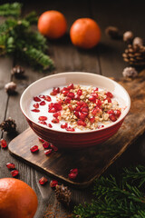 Yoghurt with granola and pomegranate seeds. Christmas photo