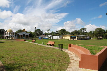 town park with green areas and church