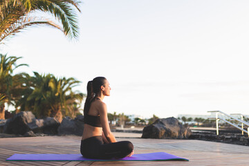 Young beautiful woman meditating outdoors.