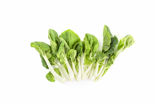 Vertical Shot Of Green Leafy Vegetables Isolated On A White Background