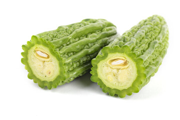 Closeup shot of sliced green bitter gourds isolated on a white background