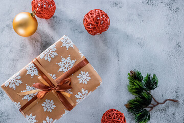 Christmas and New Year concept. A gift in a beautiful package on a gray background.