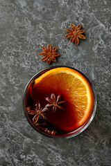Glass of mulled wine on black smokey table