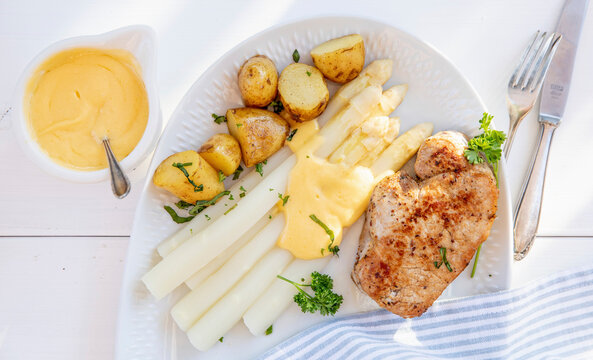 Pork steak with white asparagus and sauce Hollandaise