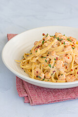 Creamy Shrimp Pasta Garnished with Basil and Chili Peppers Vertical Photo