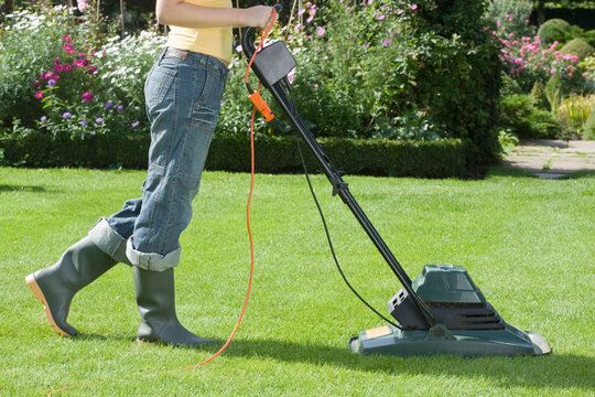 Woman Mowing Lawn