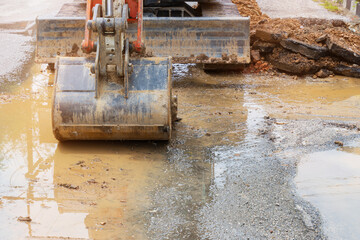 backhoe dig repair broken water line pipe main plumbing on road