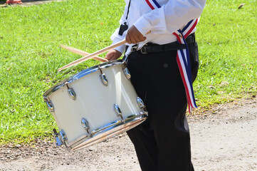 person in uniform playing drum, parade