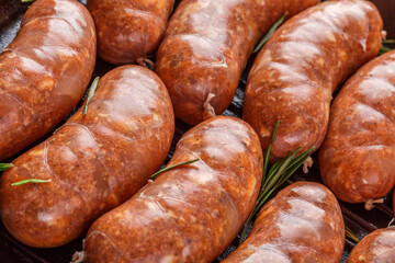 Grilled sausages, homemade,cast iron skillet or frying pan with tomatoes, garlic and rosemary. Brazilian barbecue. copy space