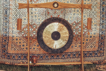Traditional oriental gong on a beautiful ornamental background.