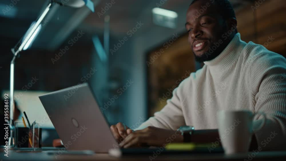Poster handsome black african american man having an online video call on a laptop computer in creative off