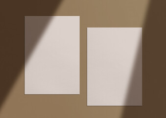 Two empty sheets of white paper with a transparent shadow. Background with sunlight. Mockup. Template for branding identity. Blank objects for placing your design. Flat lay. Top view. 