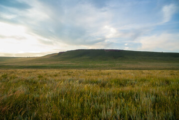 Panorama of cloudy sky and hilly steppe