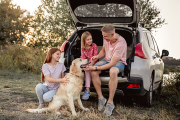 Father with daughters and golden retriever
