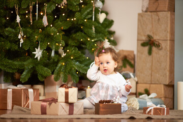 Little cute girl with gifts and box with christmas decor