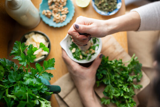 Pesto verde with parsley and mint being made in a mortar