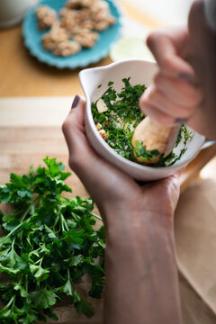 Pesto verde with parsley and mint being made in a mortar