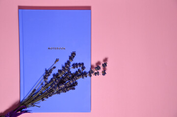 Blue notebook and lavander background with a place for text