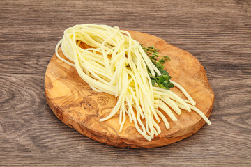 Chechil spaghetti cheese over board