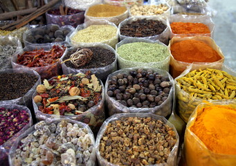 Containers lined with colored spices, Nizwa Souk, Oman