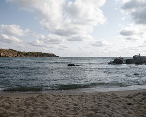 Fototapeta na wymiar Coast of sea with clouds and sand of beach